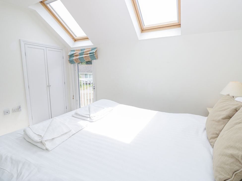 A bedroom with a bed and skylight at Vermont 4 in Yarmouth