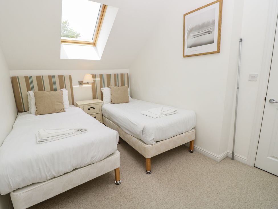 A bedroom with two single beds and a sky light at Vermont 4 in Yarmouth