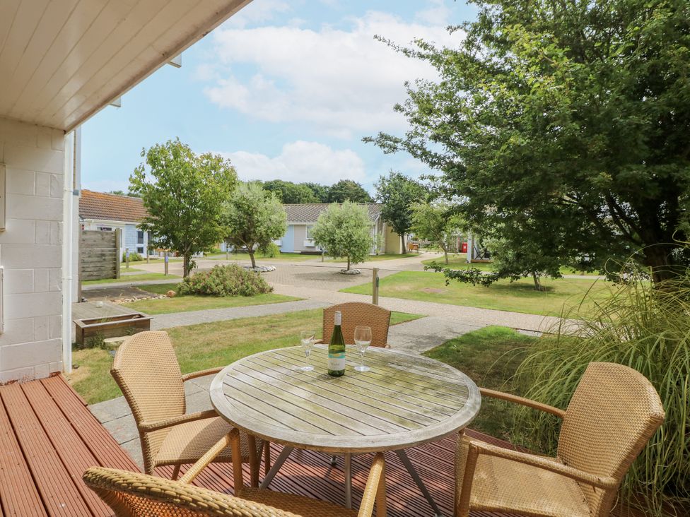 An outdoor seating area with a table and chairs at Vermont 4 in Yarmouth