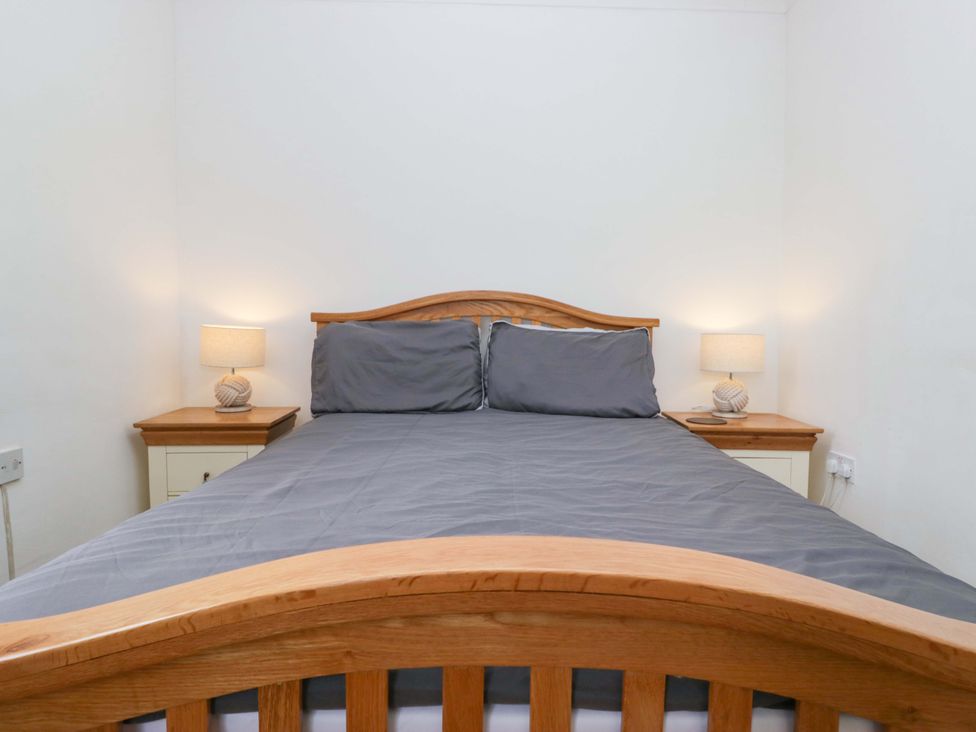 A bedroom with a bed and lamps on nightstands at Duncan Square in Whitehaven