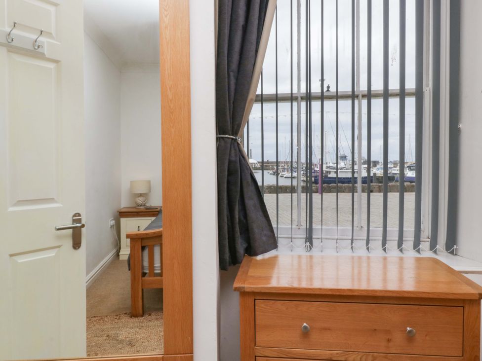 A living room with a window overlooking the marina at Duncan Square in Whitehaven