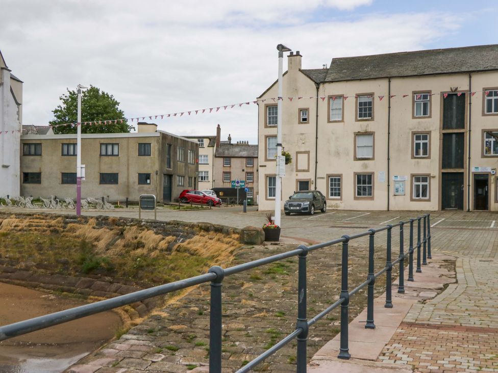 An outdoor area with buildings and parked cars at Duncan Square in Whitehaven