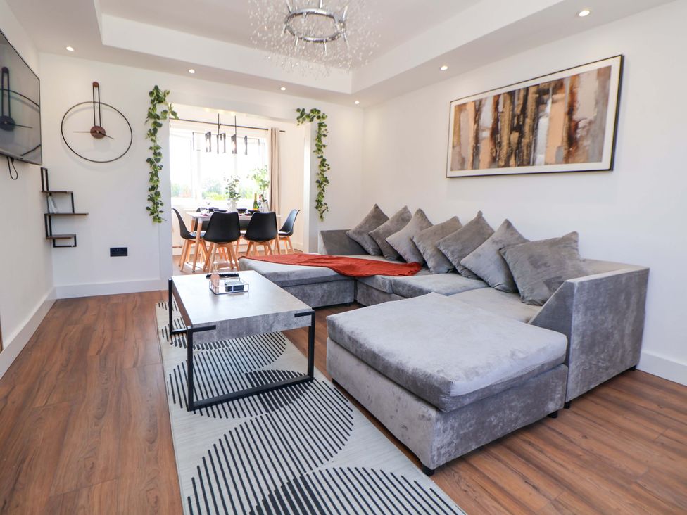 A living room with a sofa, coffee table, and dining area at 11 Coniston Road, Chester