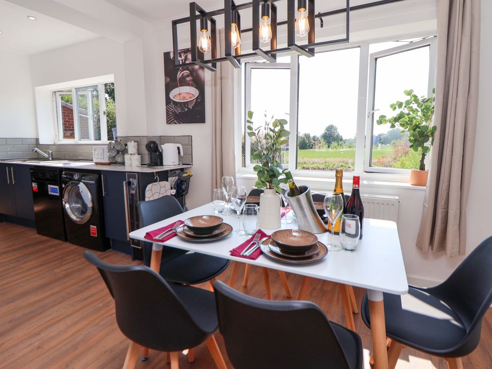 A dining room with a table set for dinner at 11 Coniston Road Chester
