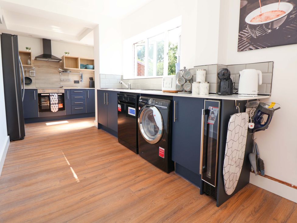 A kitchen with appliances and cabinets at 11 Coniston Road Chester
