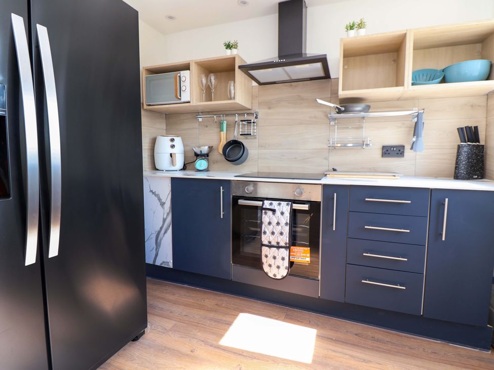 A kitchen with appliances and cabinets at 11 Coniston Road Chester