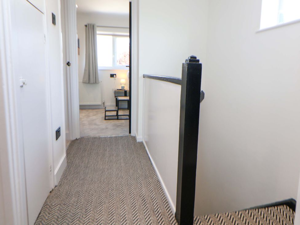 A hallway with stairs and a window at 11 Coniston Road Chester