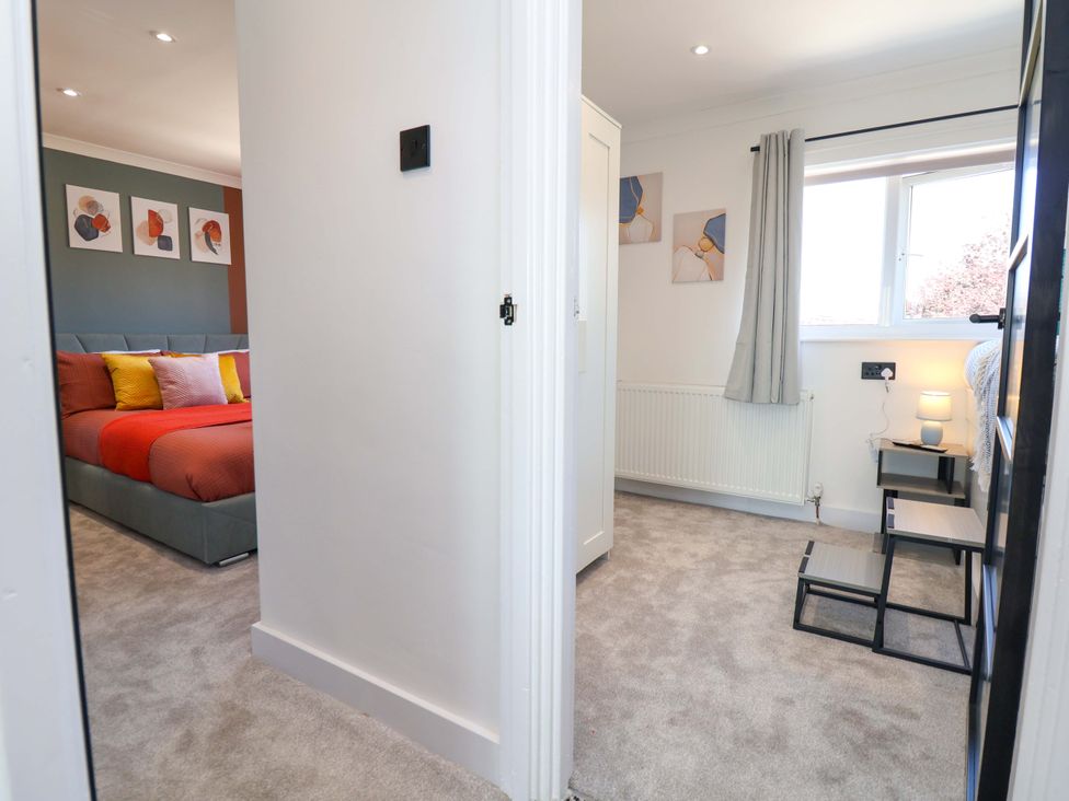 A bedroom with a bed and bedside table at 11 Coniston Road in Chester