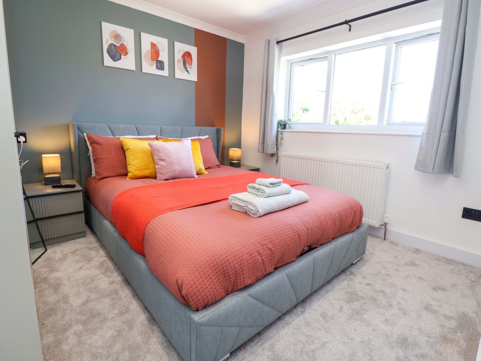A bedroom with a bed and pillows at 11 Coniston Road Chester