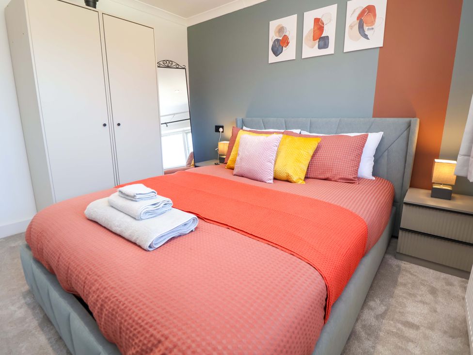 A bedroom with a bed and wardrobe at 11 Coniston Road Chester