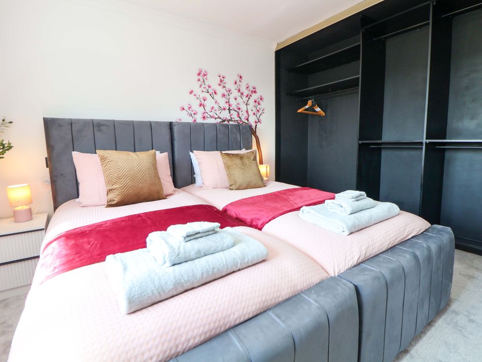 A bedroom with twin beds and decorative elements at 11 Coniston Road Chester
