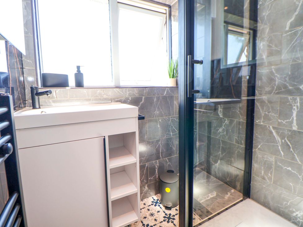 A bathroom with a sink and shower at 11 Coniston Road Chester