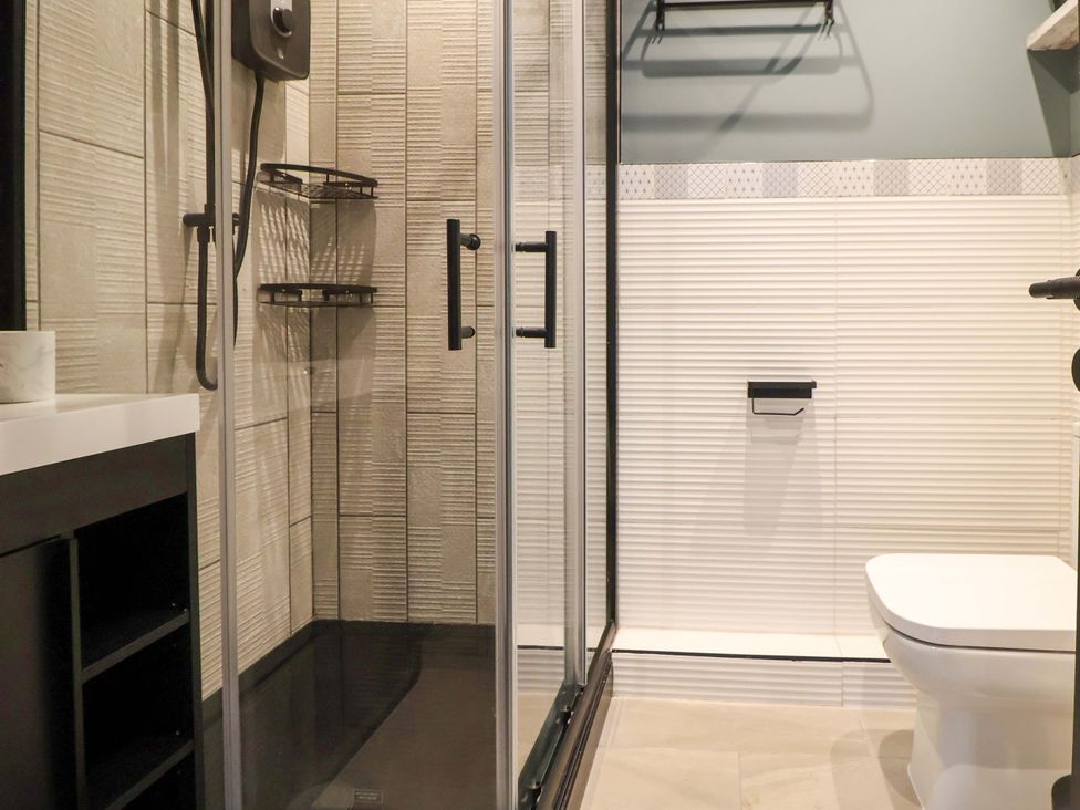 A bathroom with a shower and toilet at 11 Coniston Road in Chester