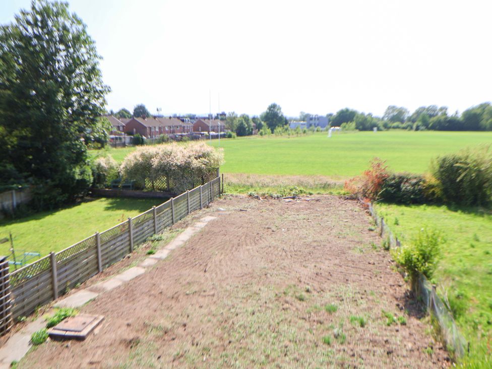 A garden area with grass and fence at 11 Coniston Road Chester