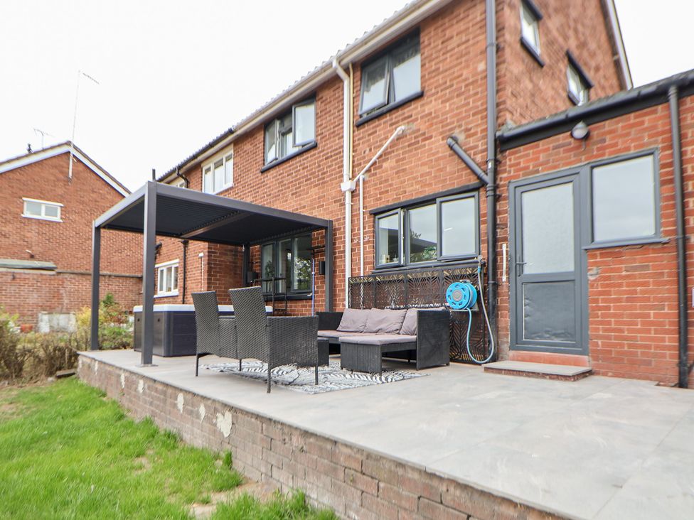 A patio with a table and chairs at Melody Place in Chester