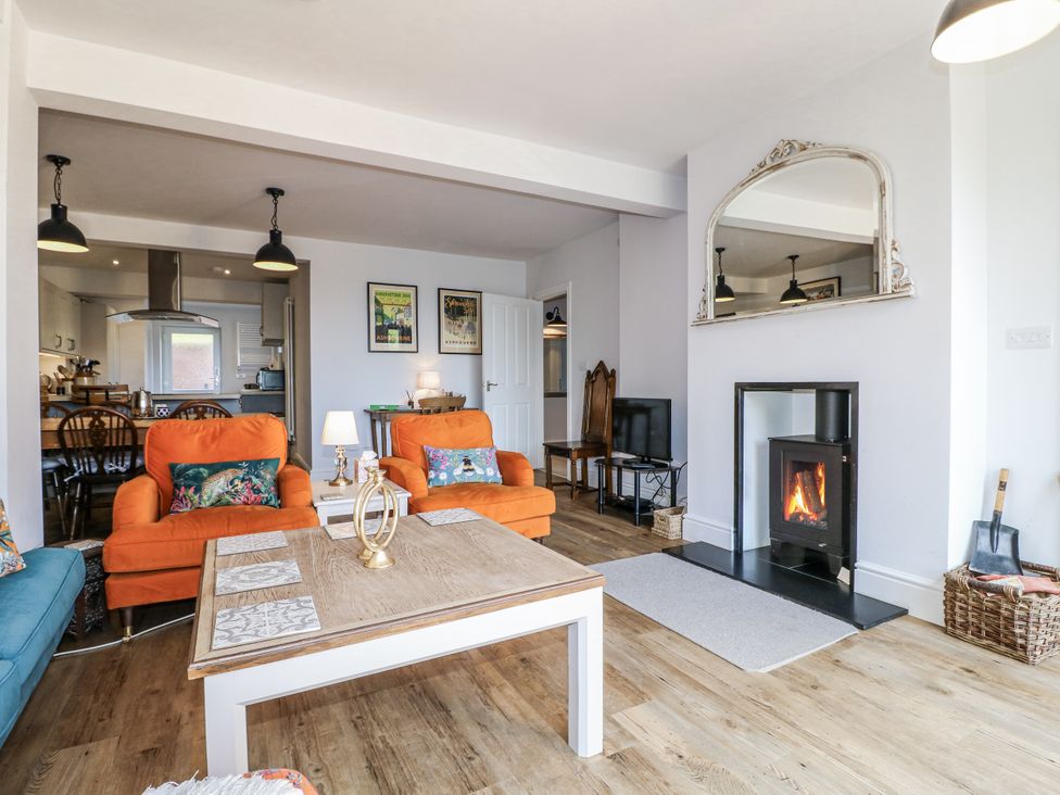 A living room with sofas and a fireplace at The View @ Orchard View Hognaston