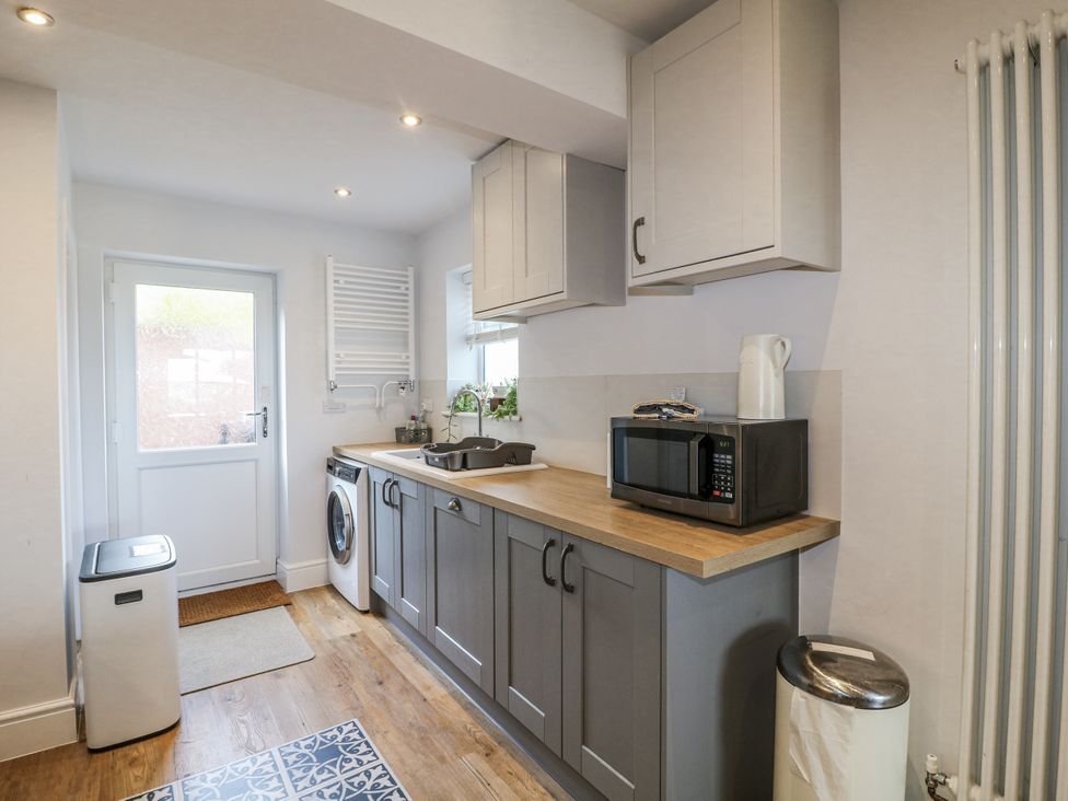 A kitchen with a sink and microwave at The View @ Orchard View Hognaston