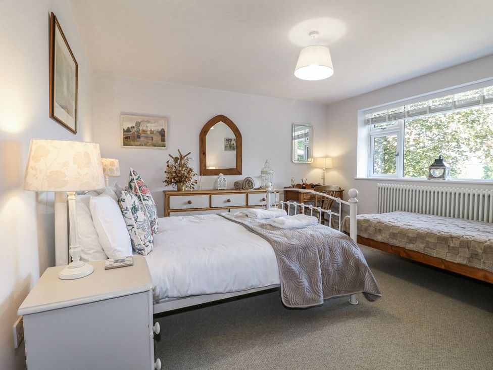 A bedroom with a bed and a bedside table at The View @ Orchard View in Hognaston