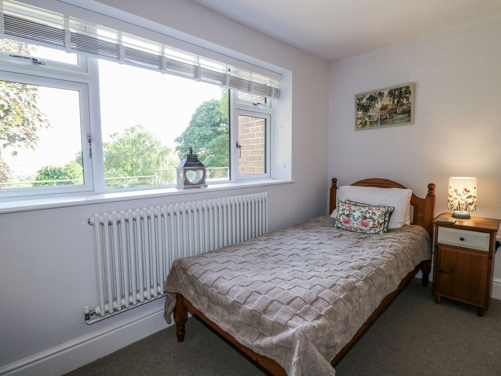 A bedroom with a bed and lamp at The View @ Orchard View in Hognaston
