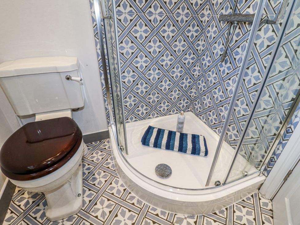 A bathroom with a shower and toilet at The View @ Orchard View in Hognaston