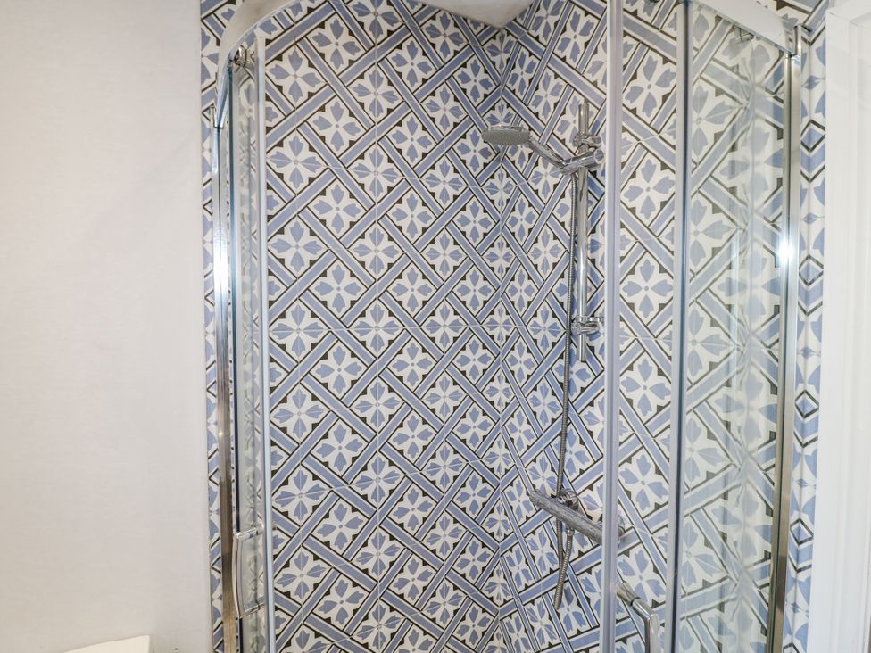 A shower with tiled walls and glass doors at The View @ Orchard View in Hognaston