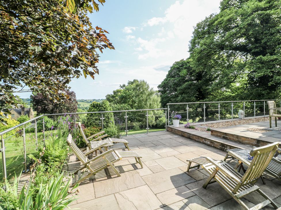 A outdoor seating area with chairs and planters at The View @ Orchard View in Hognaston