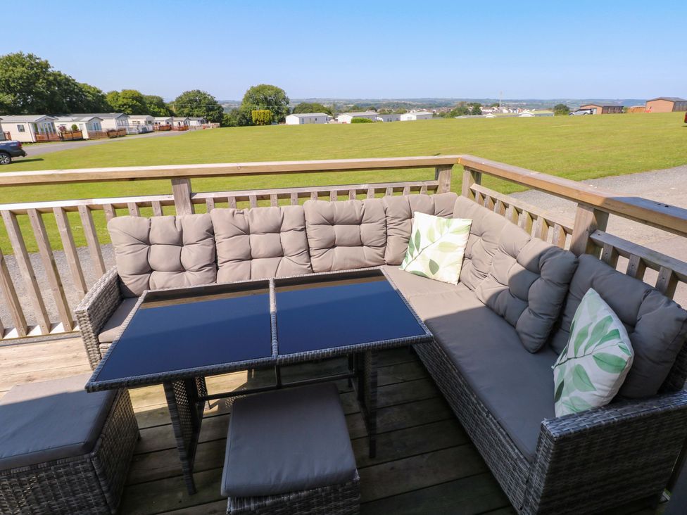A seating area with a sofa and table at No 13 Broadfield Farm Holiday Park in Saundersfoot