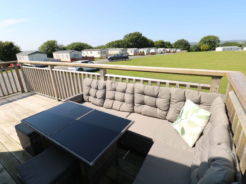 An outdoor seating area with a sofa and table at No 13 Broadfield Farm Holiday Park, Saundersfoot