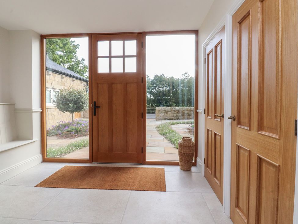 An entrance hall with doors and a mat at Alston House