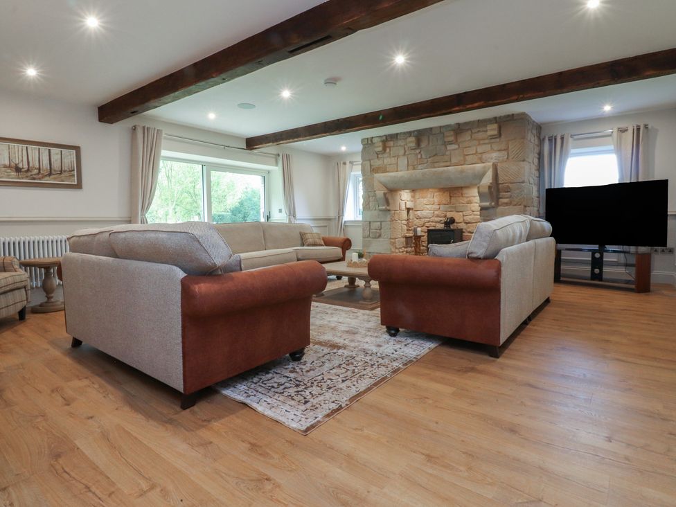 A living room with sofas and a fireplace at Alston House
