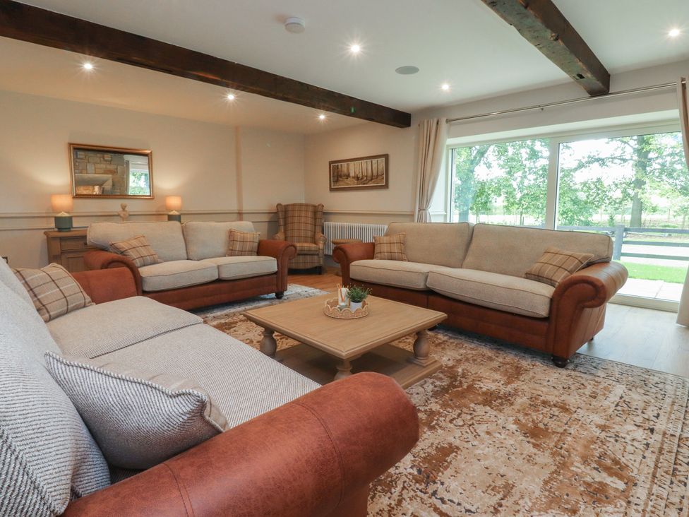 A living room with sofas and a coffee table at Alston House