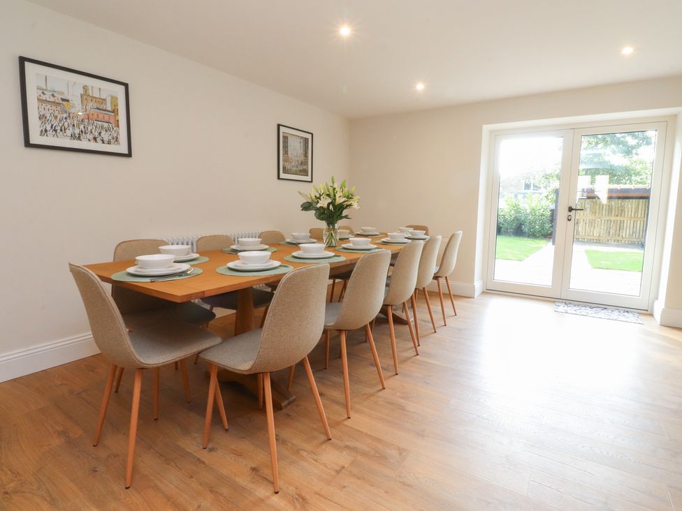 A dining room with a table set for meal at Alston House 