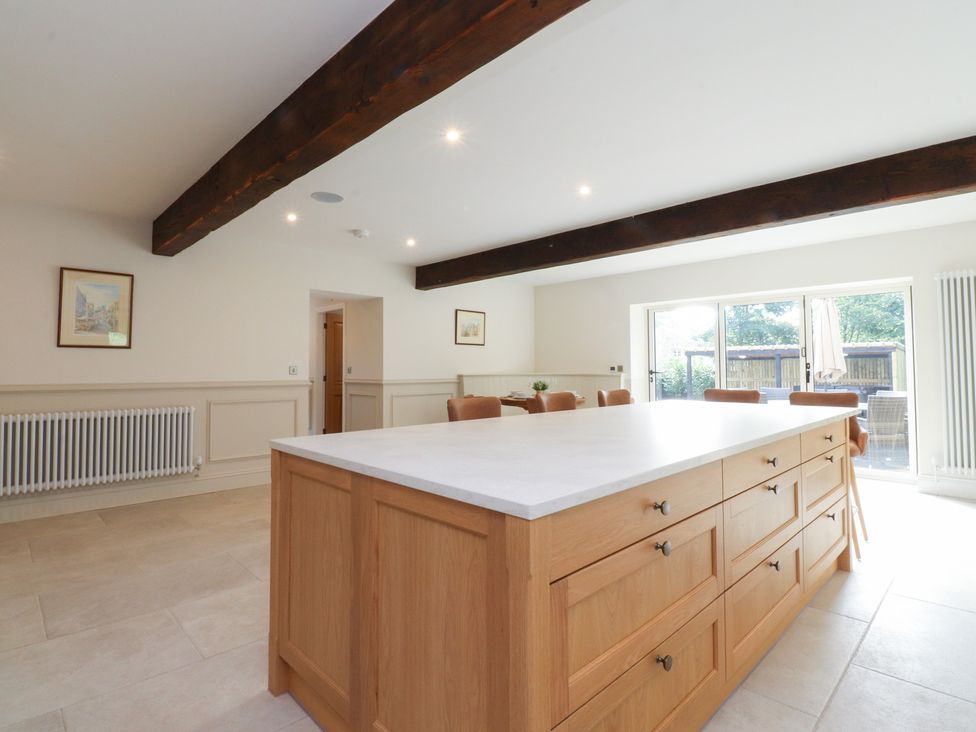 A kitchen with an island and dining table at Alston House