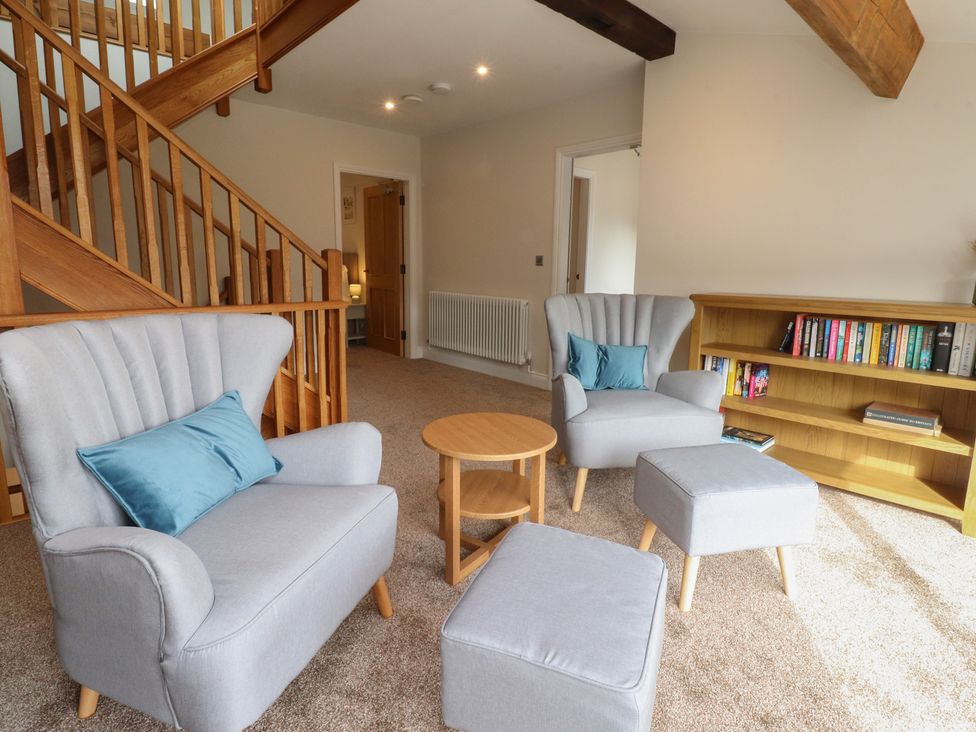 A living room with a staircase and furniture at Alston House