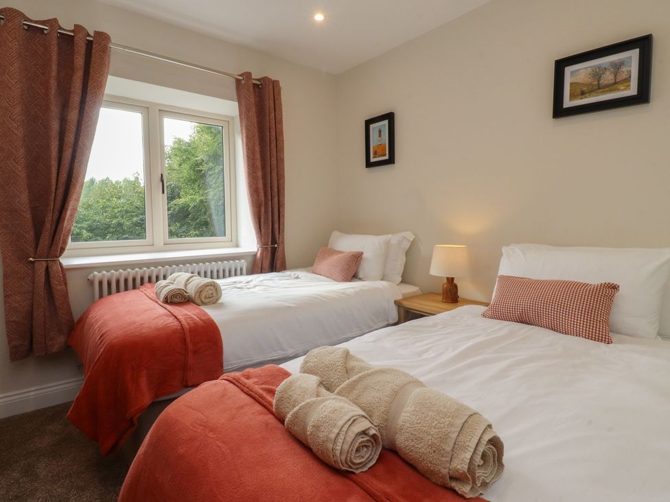 A bedroom with two beds and a window at Alston House 
