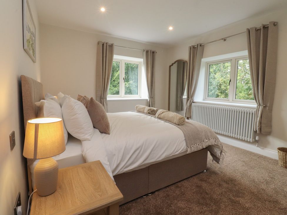 A bedroom with a bed and windows at Alston House