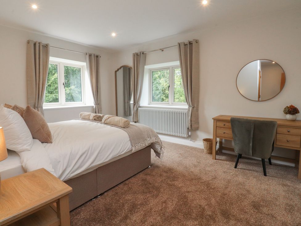 A bedroom with a bed and desk at Alston House
