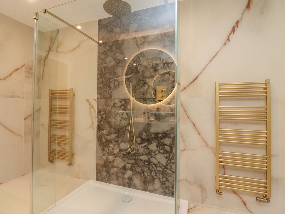 A bathroom with a shower and towel radiator at Alston House