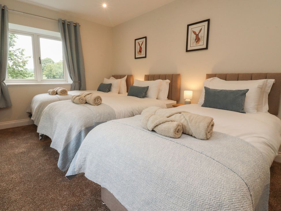 A bedroom with two beds and a window at Alston House