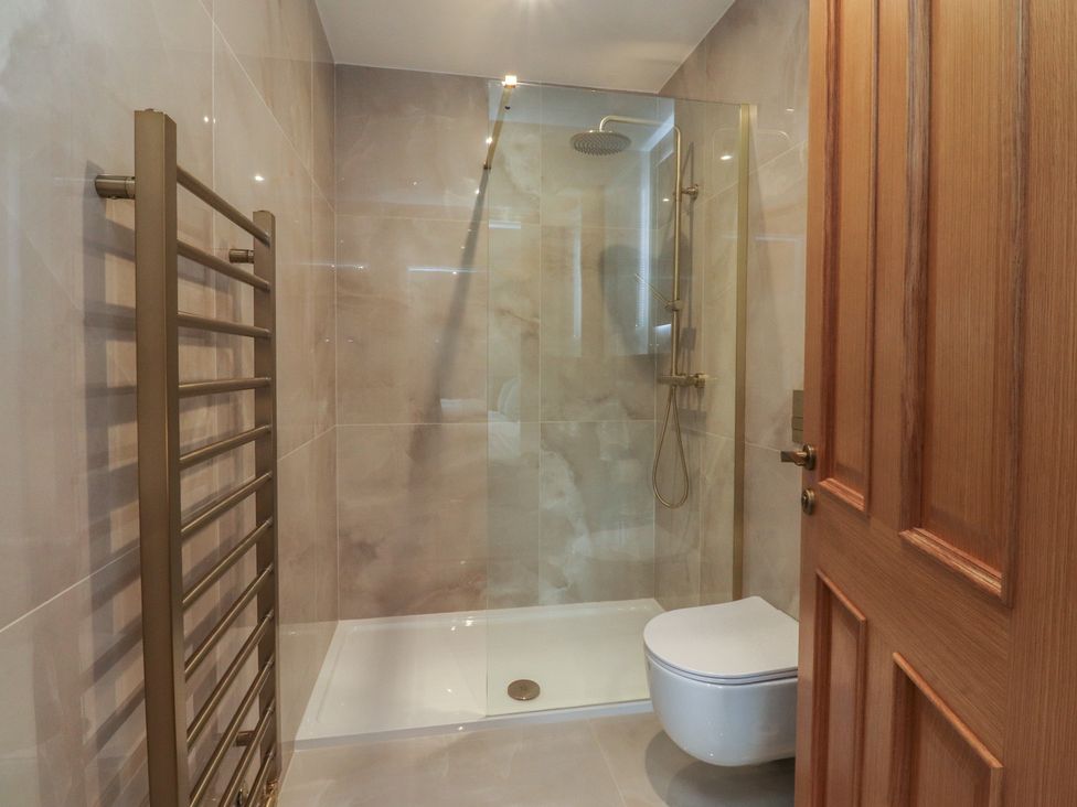 A bathroom with a shower and toilet at Alston House