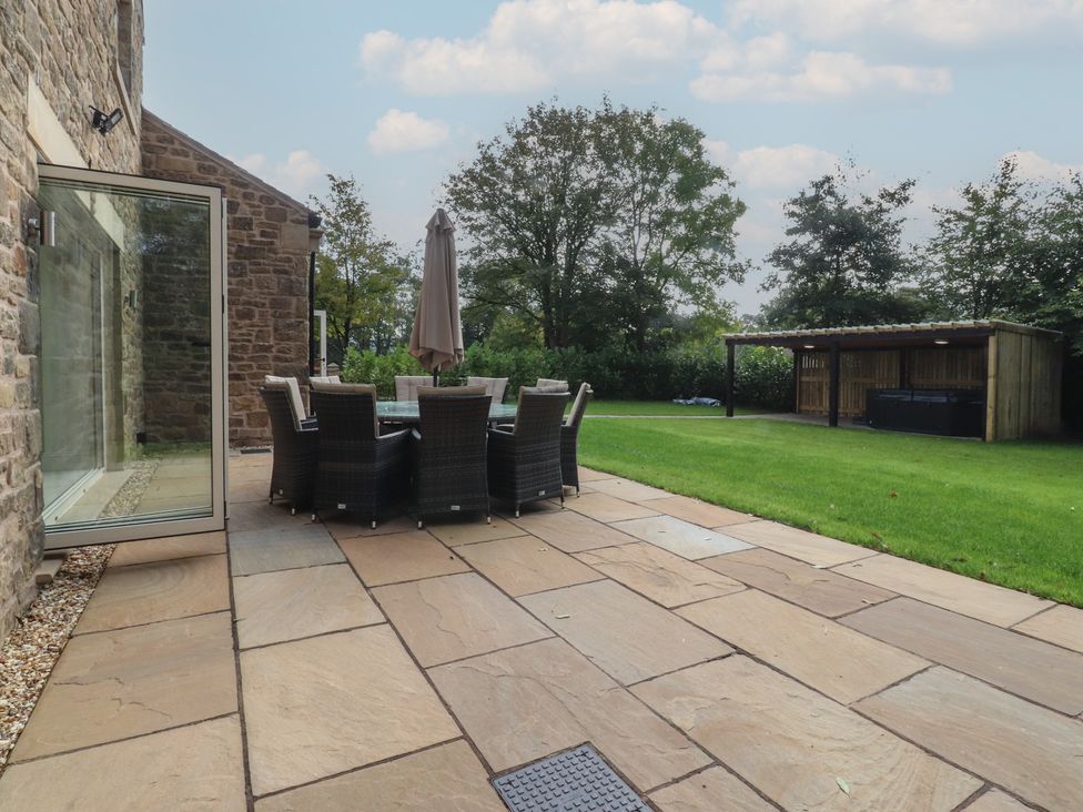 A garden patio with a table and chairs at Alston House