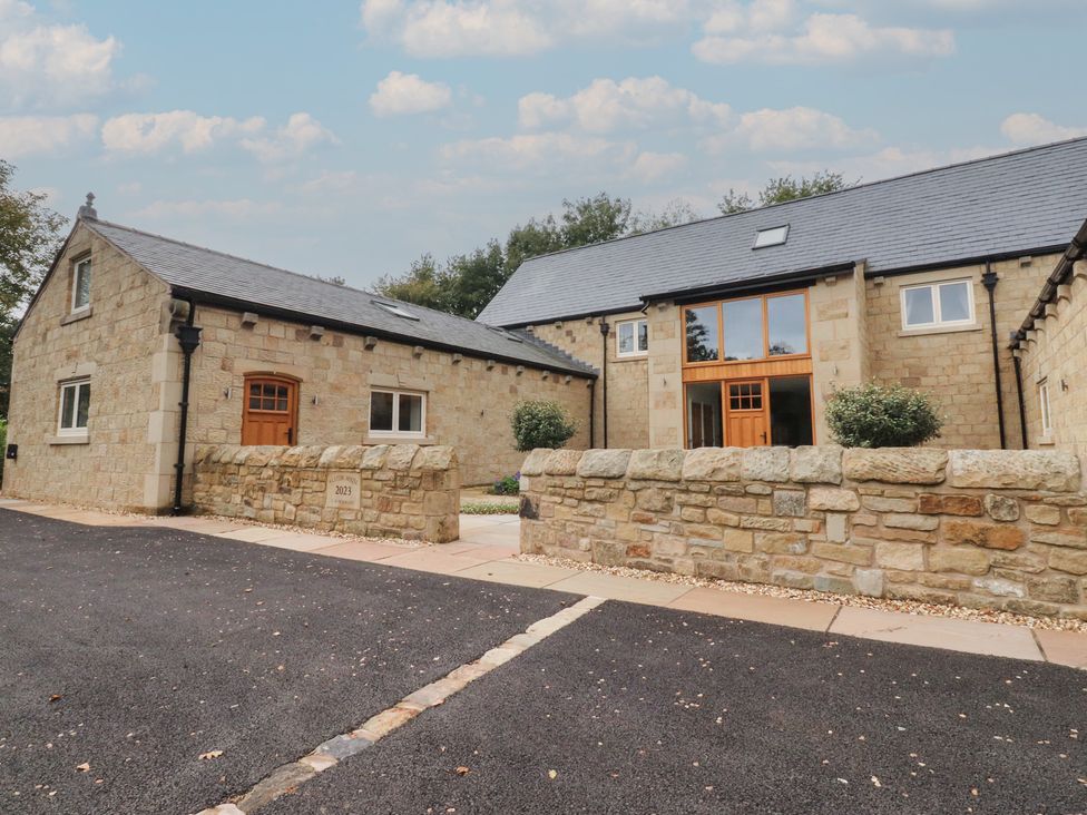 A stone house with a front door and windows at Alston House