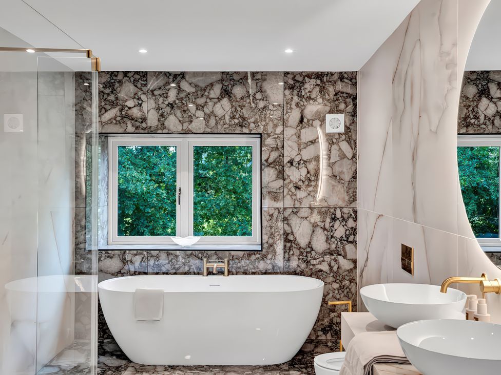 A bathroom featuring a bathtub and sinks at Alston House Longridge
