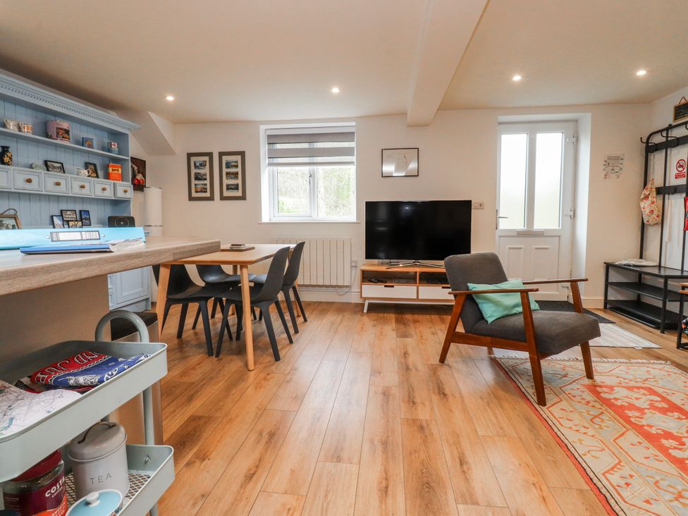 A living room with a table and chairs at Number 7 Canalside in Skipton