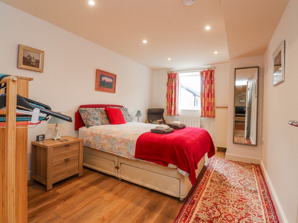 A bedroom with a bed and bedside table at Number 7 Canalside in Skipton