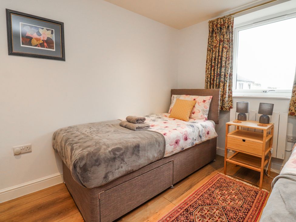 A bedroom with a single bed and bedside table at Number 7 Canalside in Skipton