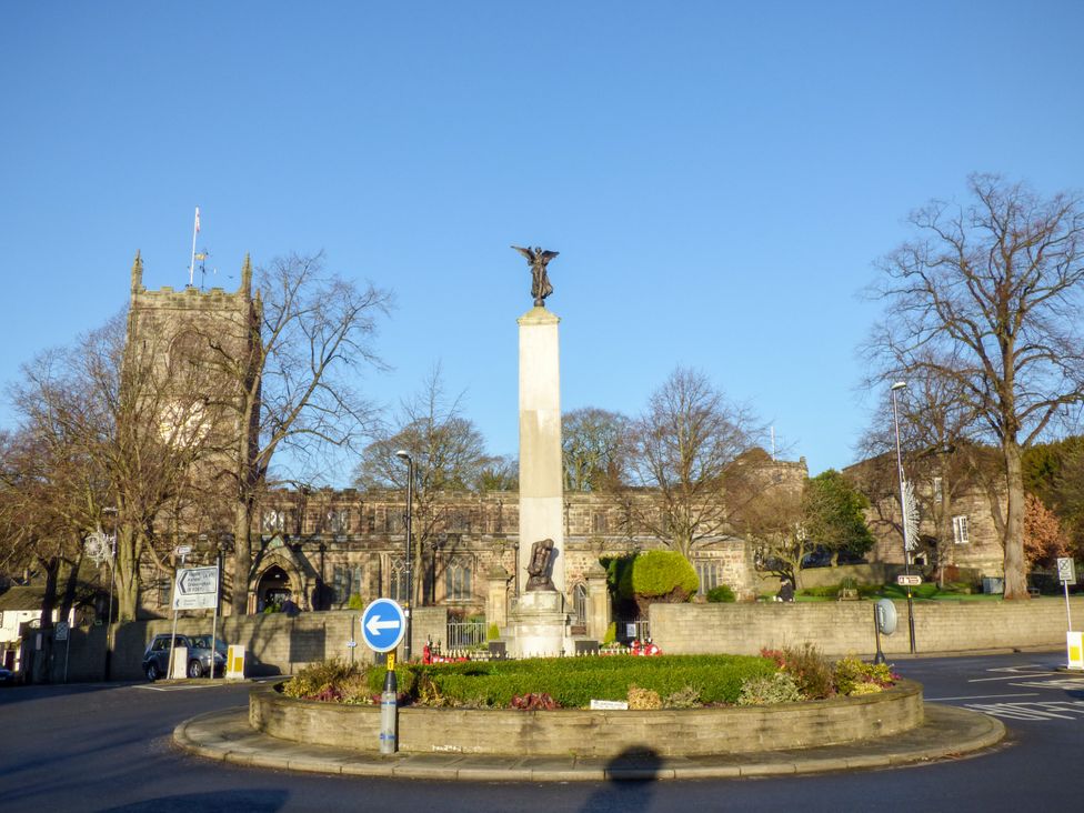 A roundabout with a memorial and church tower at Number 7 Canalside Skipton
