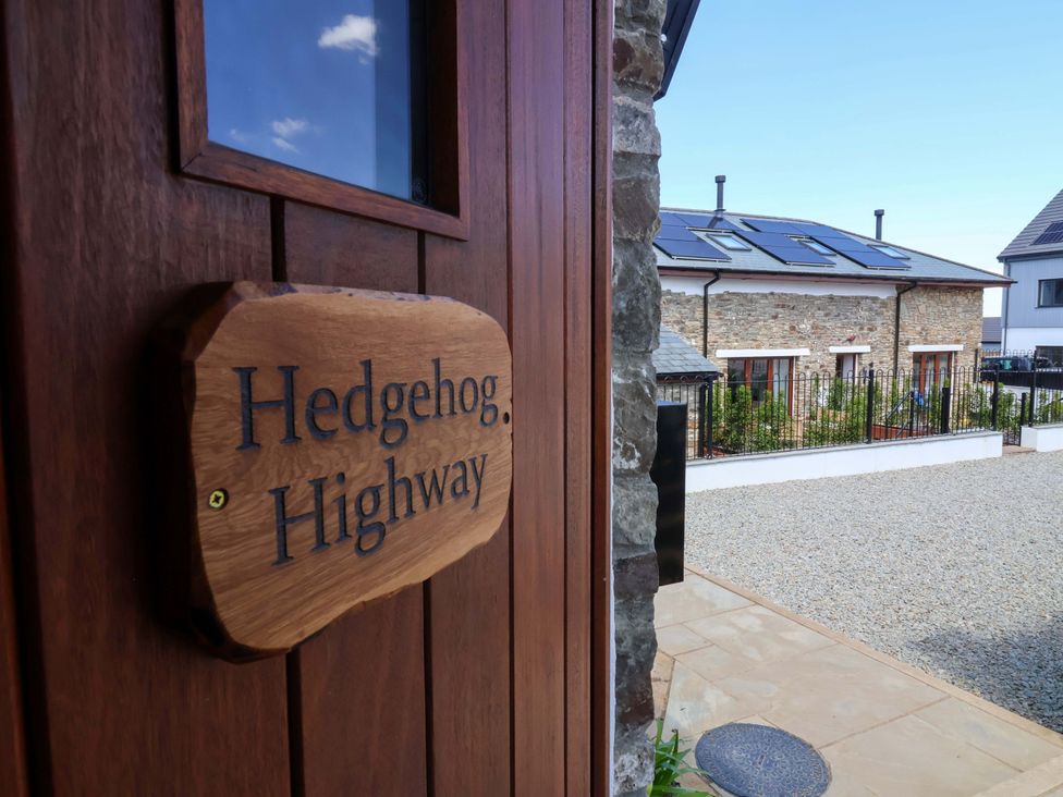 A doorway with a sign at Hedgehog Highway in Parkham
