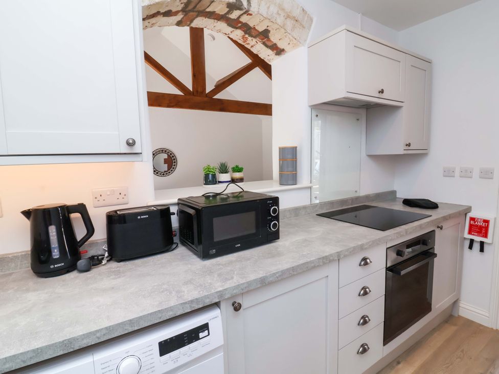 A kitchen with appliances and countertop at Hedgehog Highway in Parkham
