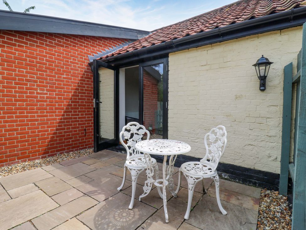 An outdoor space with a table and chairs at The Kiln in Mendham near Harleston